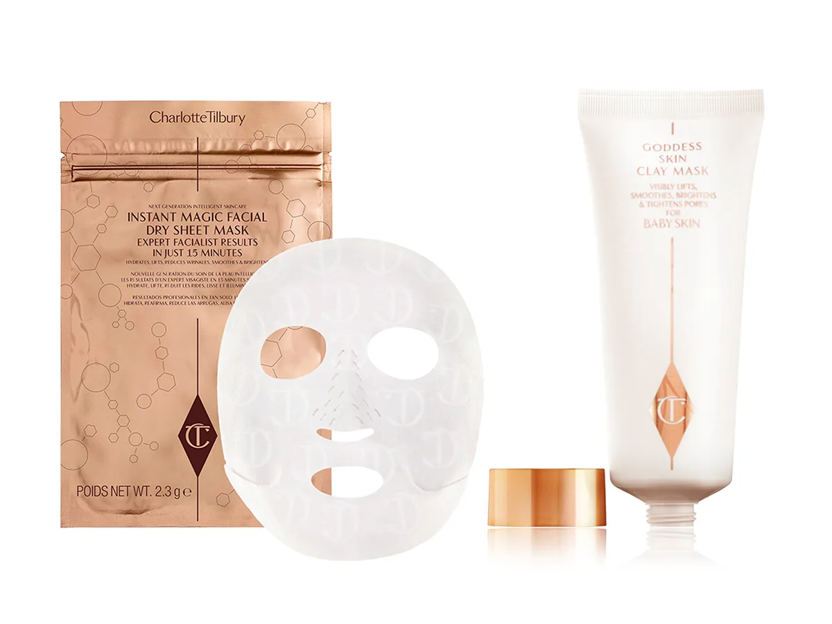 An open, hydrating sheet mask in textured fabric with its golden-coloured foil packaging behind it and a clay mask in a glowy white tube with a rose-gold-coloured lid. 