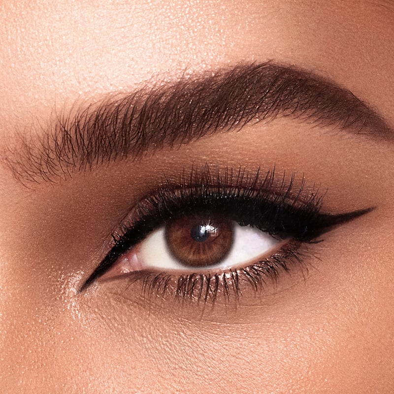 Disney 100  x Charlotte Tilbury limited-edition Charlotte's Magic Cream with Tinkerbell design on night sky backdrop