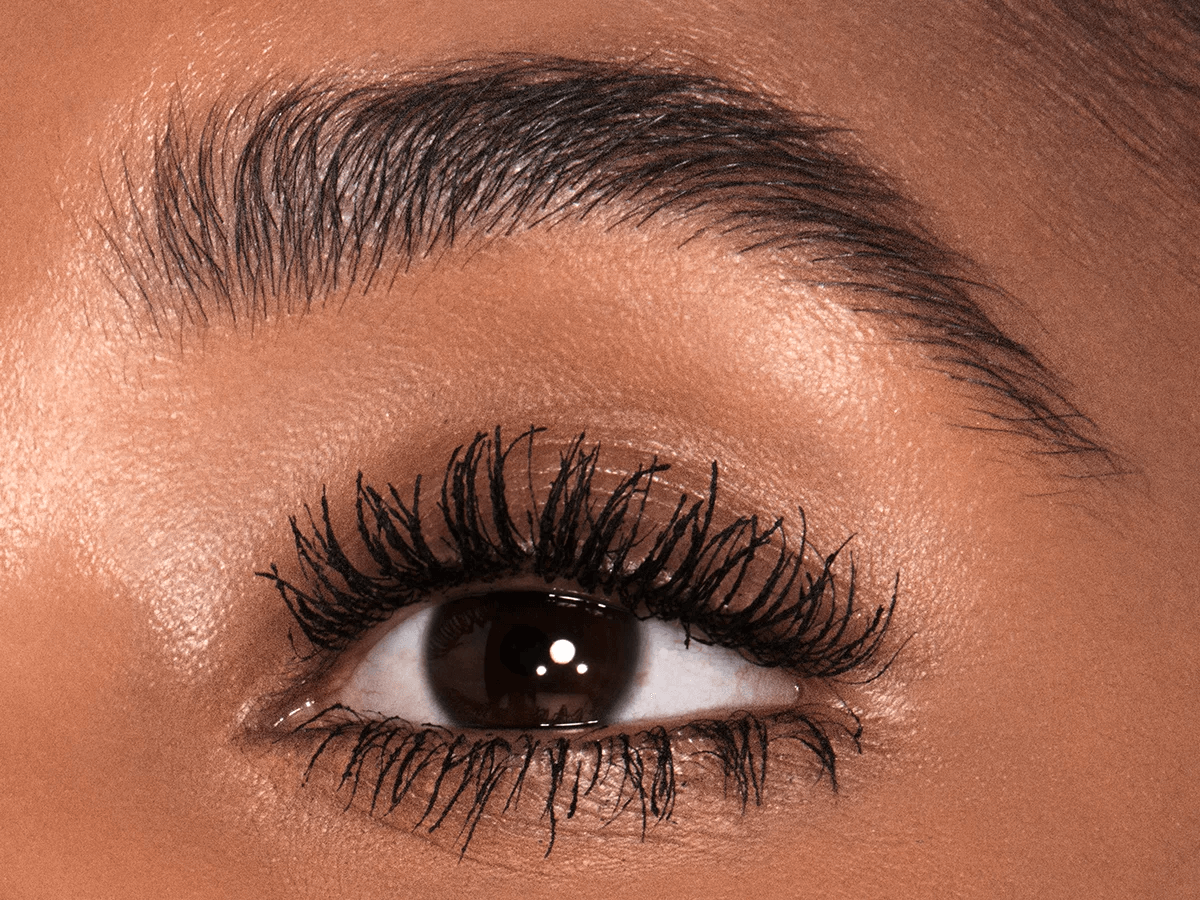 Close up on model wearing Charlotte's vertical lift effect Pillow Talk Push Up Lashes mascara